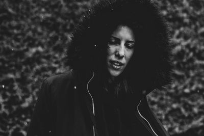 Portrait of a smiling young woman against trees