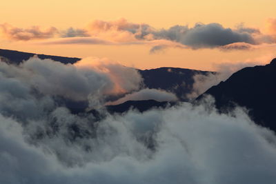 Scenic view of cloudscape covering mountains