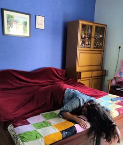 Woman sleeping on bed at home