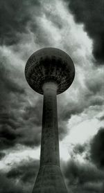 Low angle view of tower against cloudy sky