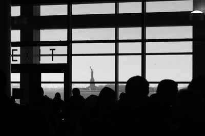 Silhouette people seen through glass window