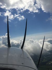 Silhouette of windmill against cloudy sky