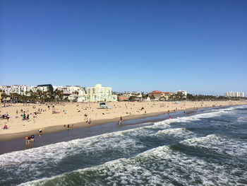 View of beach against clear blue sky