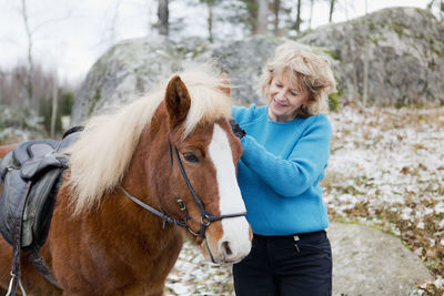 Senior woman with icelandic horse