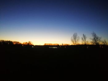 Silhouette landscape against clear sky during sunset