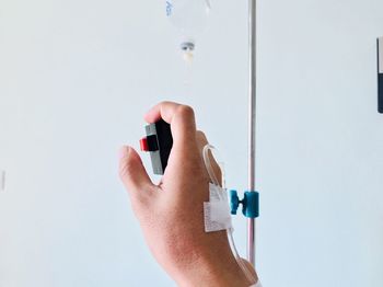 Cropped hand with iv drip in hospital