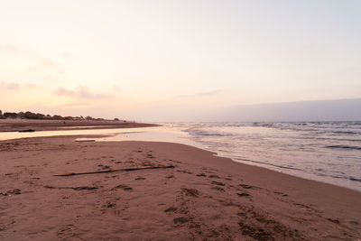 Scenic view of beach against sky during sunset