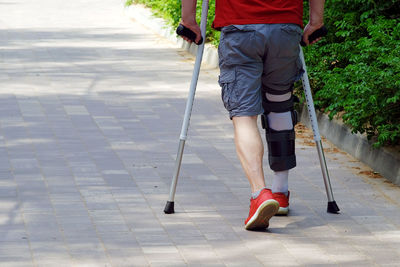 Low section of man walking on footpath