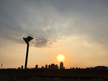 Low angle view of silhouette buildings against sky during sunset