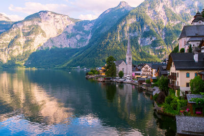 Scenic view of lake by buildings against sky