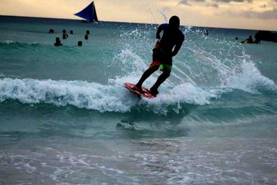 People surfing in sea