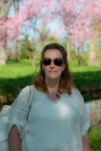 Portrait of young woman wearing sunglasses standing outdoors