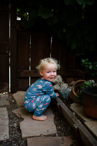 Portrait of cute girl sitting outdoors