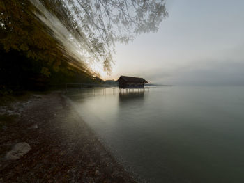 Scenic view of sea against sky at dawn