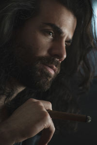 Close-up portrait of young man smoking