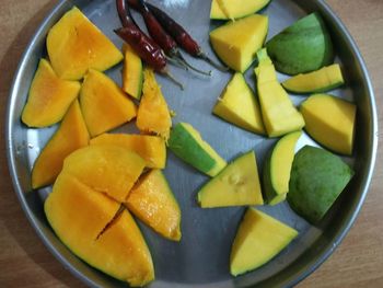 High angle view of chopped fruits in bowl on table