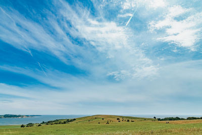 Scenic view of landscape against cloudy sky
