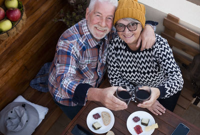 Portrait of smiling senior couple on table