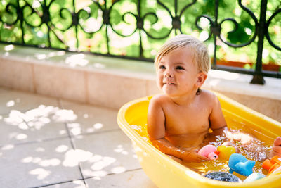 Portrait of cute boy in water