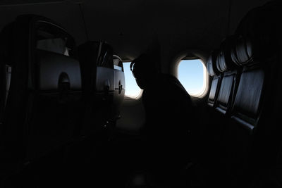 Silhouette people sitting in airplane