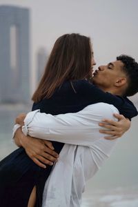 Side view of couple hugging