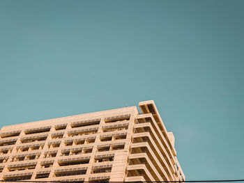 Low angle view of building against clear blue sky