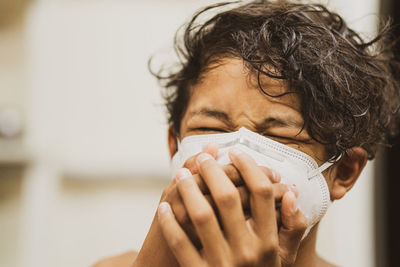 Close-up portrait of woman wearing hat at home