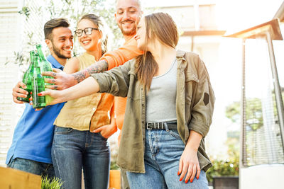 Friends toasting beer bottles outdoors