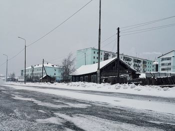 Snow covered railroad tracks against sky