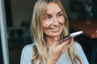 A woman says a voice message on her mobile phone. modern online communication technologies.