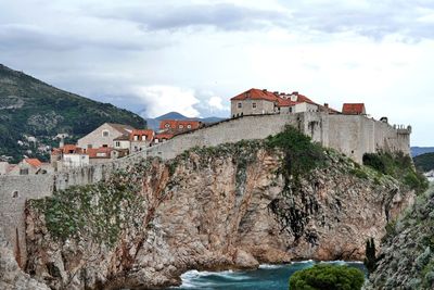 Buildings against sky with waterfront