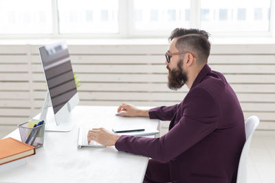 Side view of man working on table