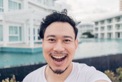 Portrait of smiling young man in swimming pool