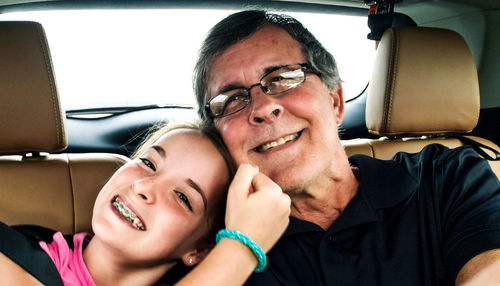 Portrait of happy young man in car