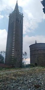 Low angle view of building on field against sky