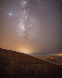 Scenic view of star field against sky at night