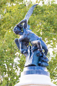 Low angle view of statue against trees