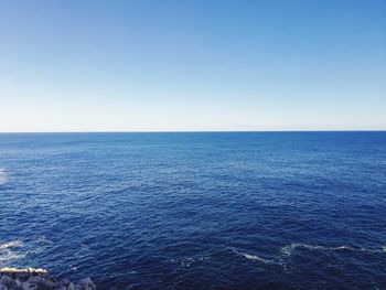 Scenic view of sea against clear blue sky