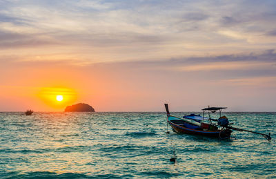Sunset at sea with fishing boat for sunset and sea lanscape background.