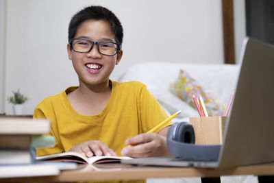 Portrait of smiling man sitting on table