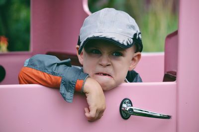 Close-up portrait of boy making a facd