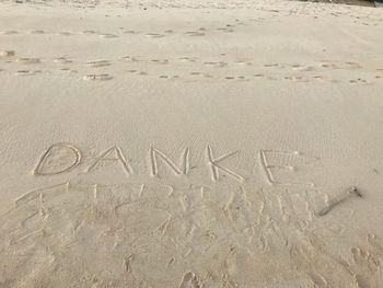 High angle view of text on beach