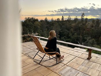 Rear view of woman sitting on chair