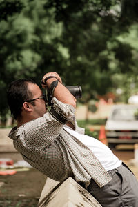 View of a man doing photography on the street