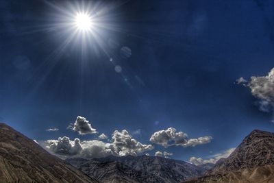 Low angle view of mountains against blue sky