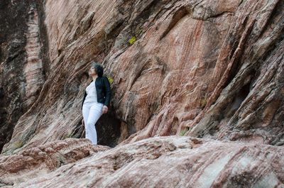 Rear view of woman on rock