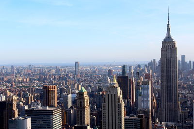 Aerial view of buildings in city against sky