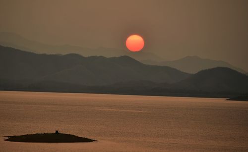 Scenic view of silhouette mountains against sky during sunset