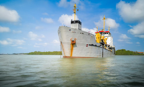 Ship sailing on sea against sky