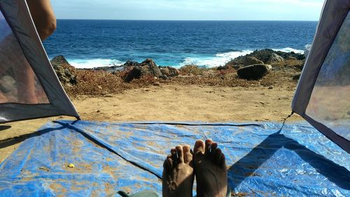 Low section of people relaxing on beach